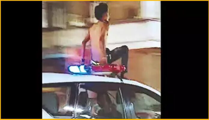 Drunken man on Police vehicle